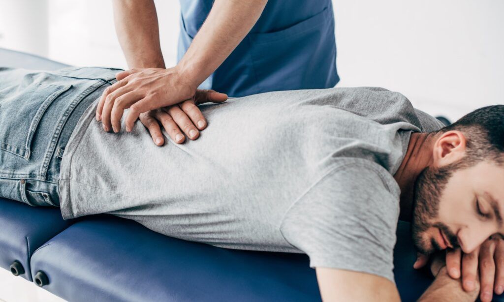 Chiropractor providing spinal care treatment to a patient in a soothing clinic environment.