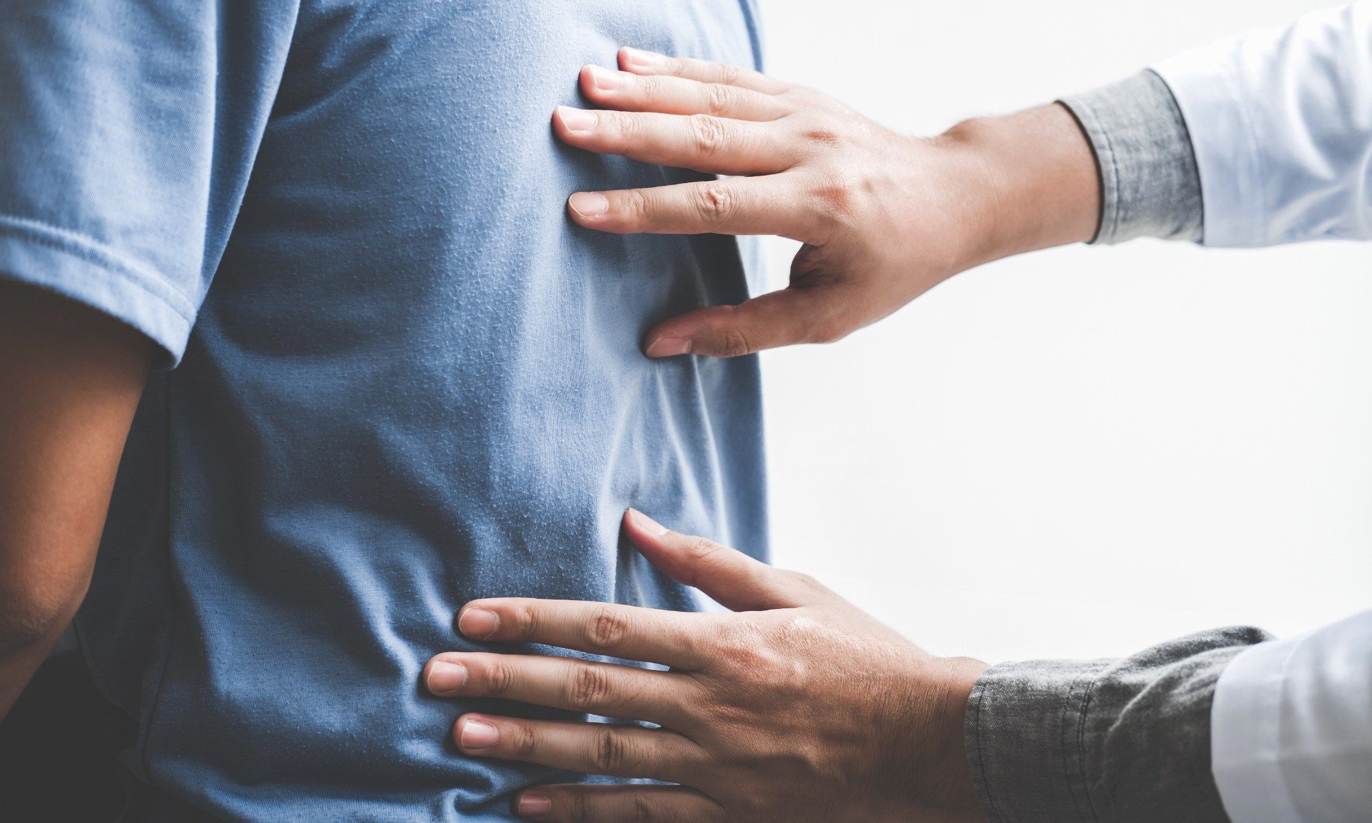 Chiropractor performing spinal adjustment on a patient with lower back pain.