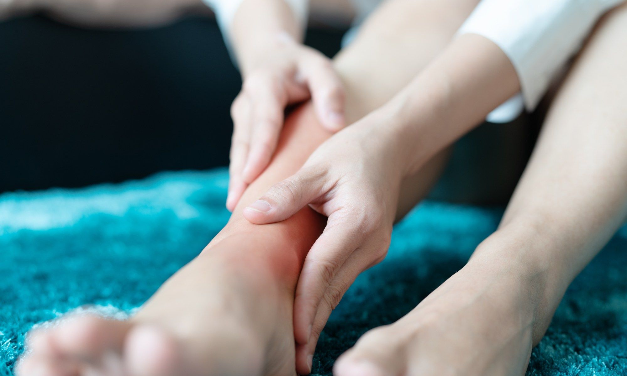 CHIROPRACTIC SERVICES 3 Chiropractor consulting a patient about ankle pain treatment at Spinal Care in Sydney, serving Ingleburn and Kogarah Bay.