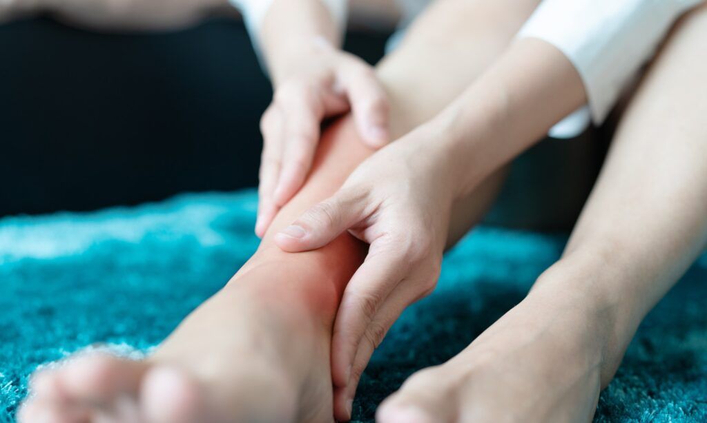 Chiropractor assessing a patient with ankle pain at Spinal Care clinic in Sydney.